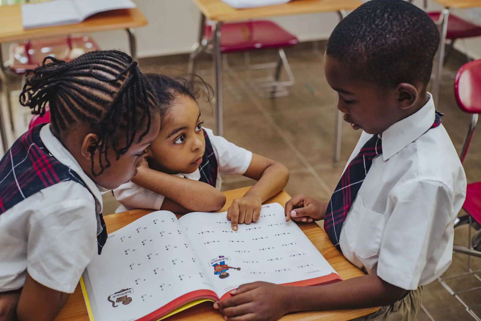 Students working together on a maths worksheet.