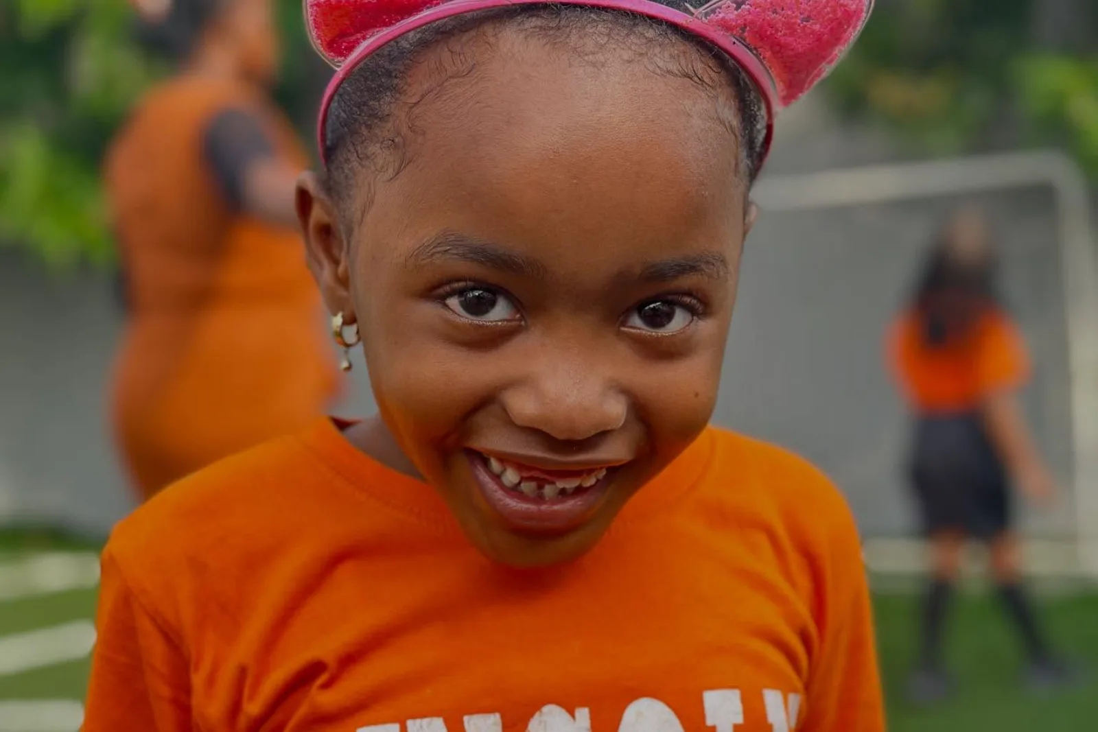 A student smiling during outdoor activity time.